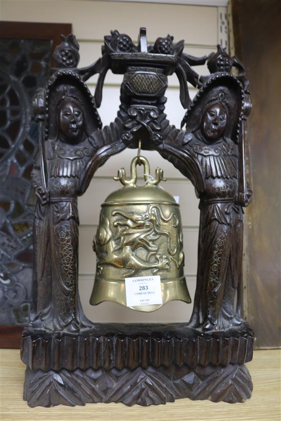 A Chinese bronze bell with hardwood frame